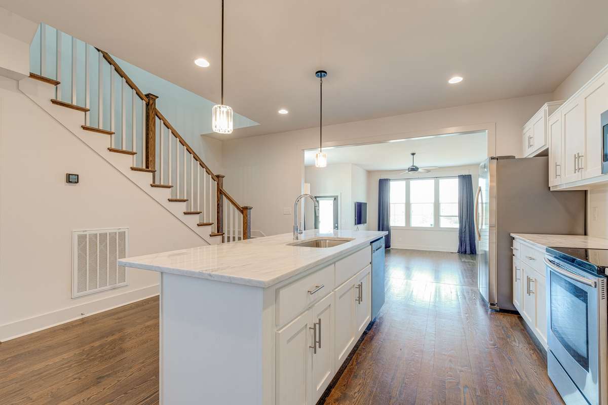 Perfect view from the top tier kitchen overlooking the massive family room and dining area just a few steps below toward the back of the house.