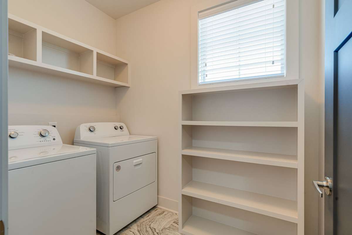 Laundry room upstairs with lots of storage