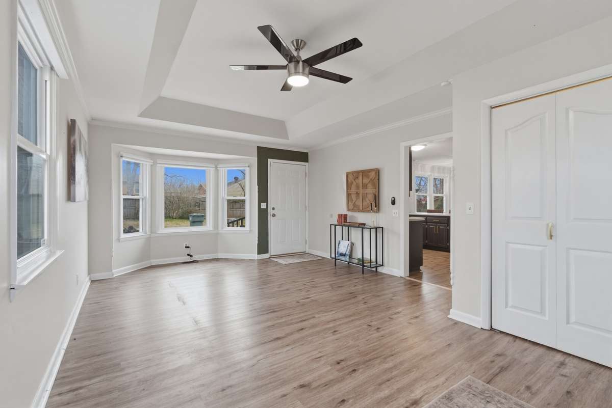 Beautiful tray ceiling and updated ceiling fan. Bay window looks over the back yard.