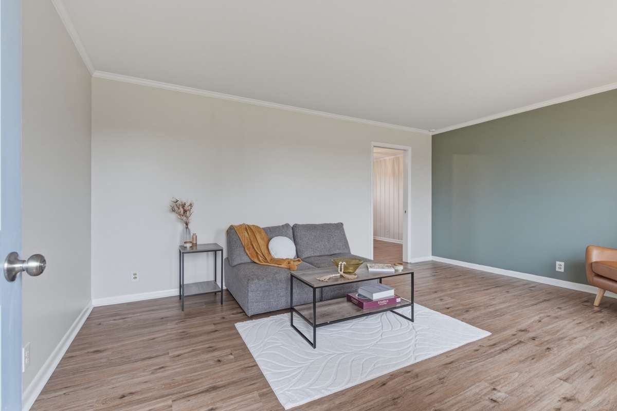 Formal Living room or den is right inside the front door with a true coat closet and beautiful accent wall. Tons of natural light!