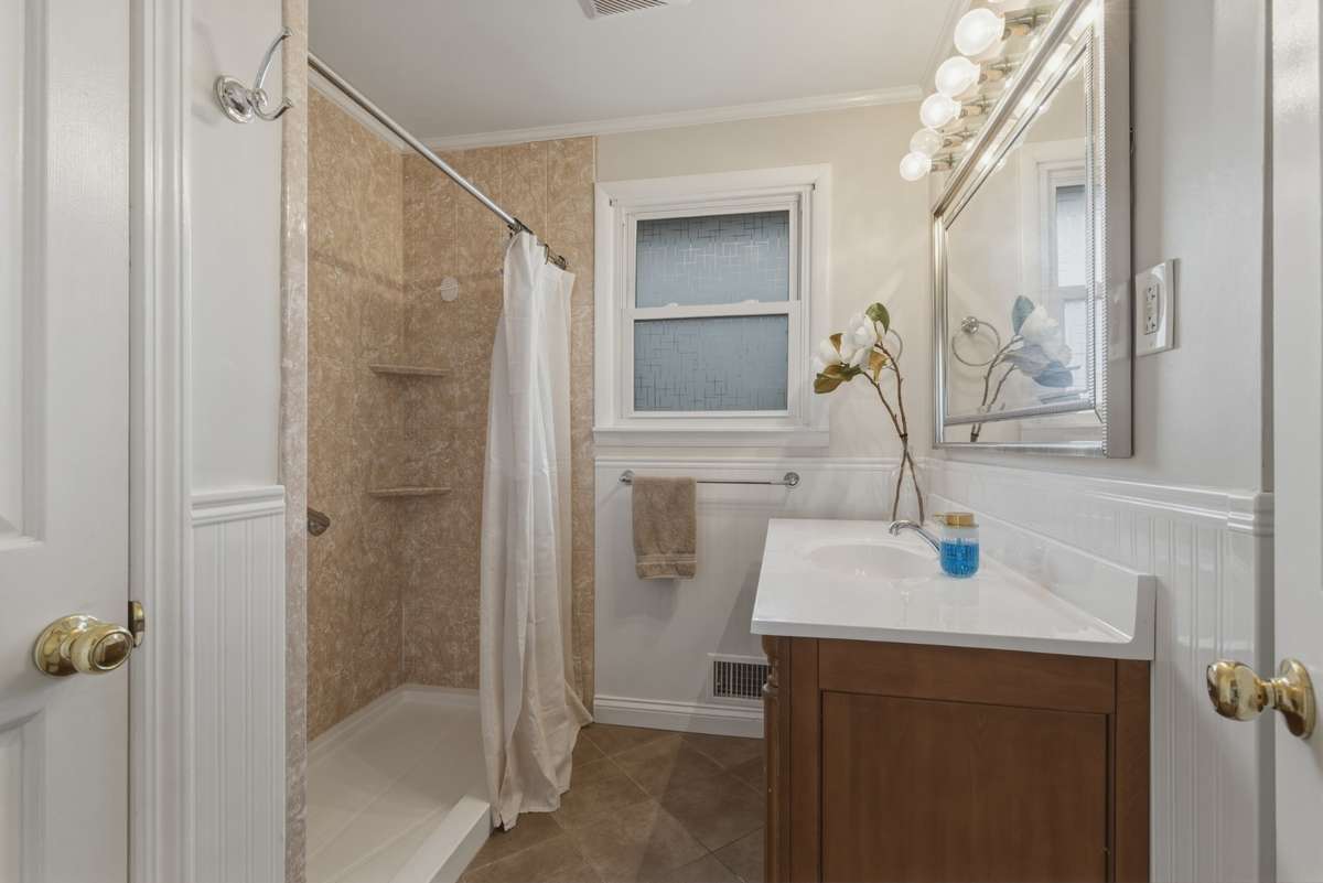 Bathroom has a spacious walk in shower and upgraded vanity.