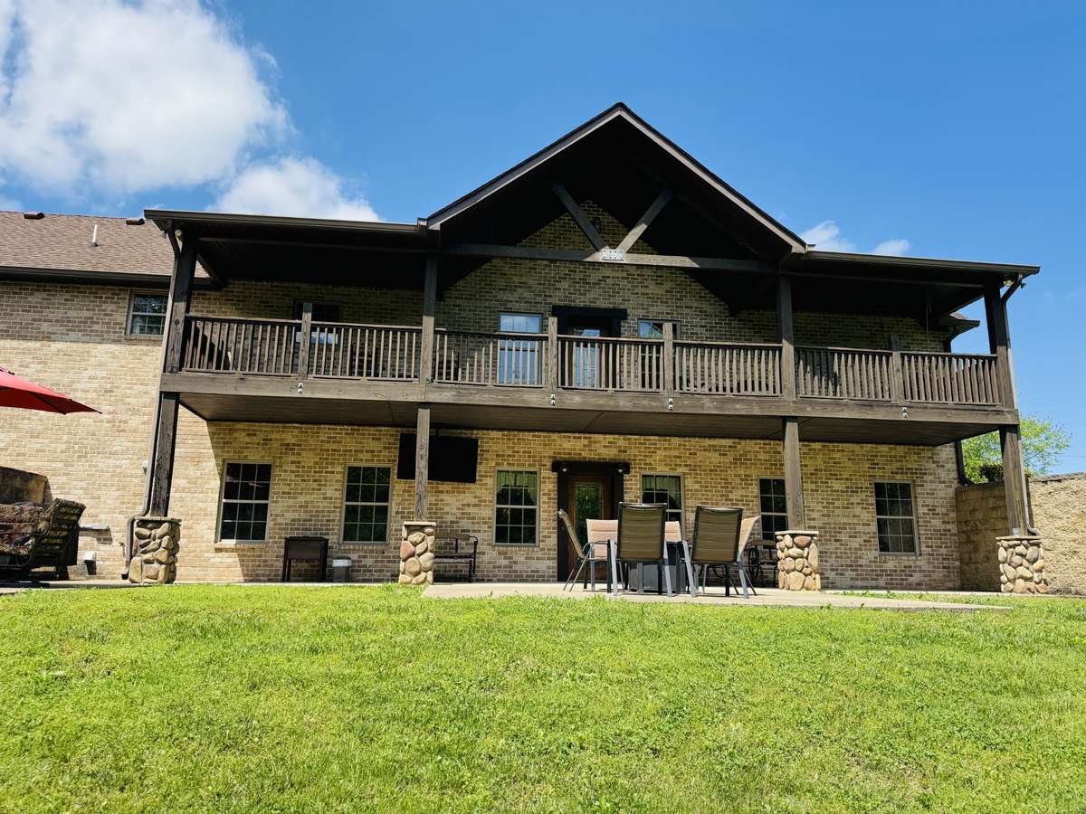 Photo of the back taken during the summer so you can see the green trees and grass, and look forward to warmer days out here!!