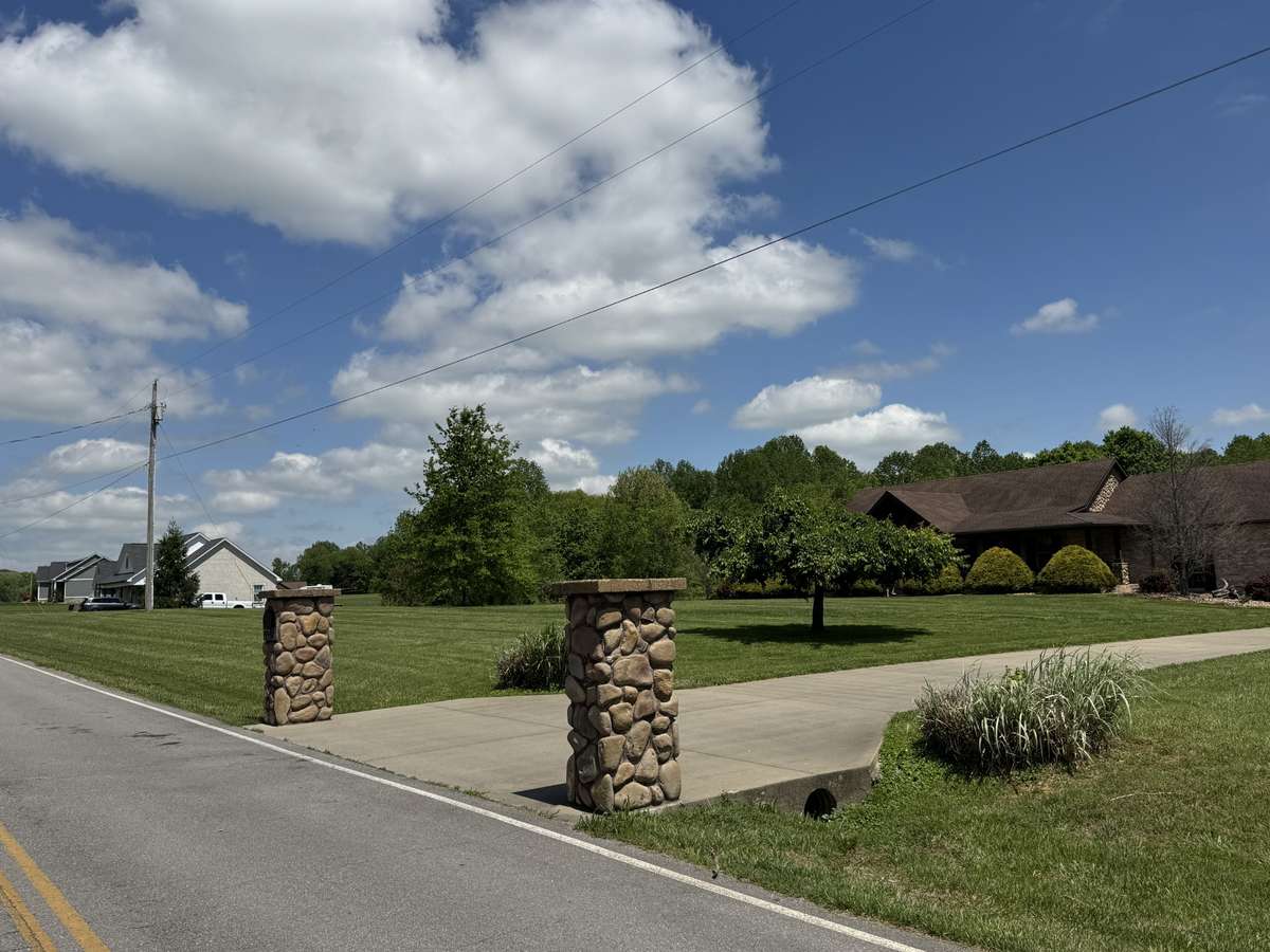 Photo of the front concrete drive and pillars to your home.  Picture from July to show how it looks lush and green.  Not a representation of weather in TN currently but to come soon.