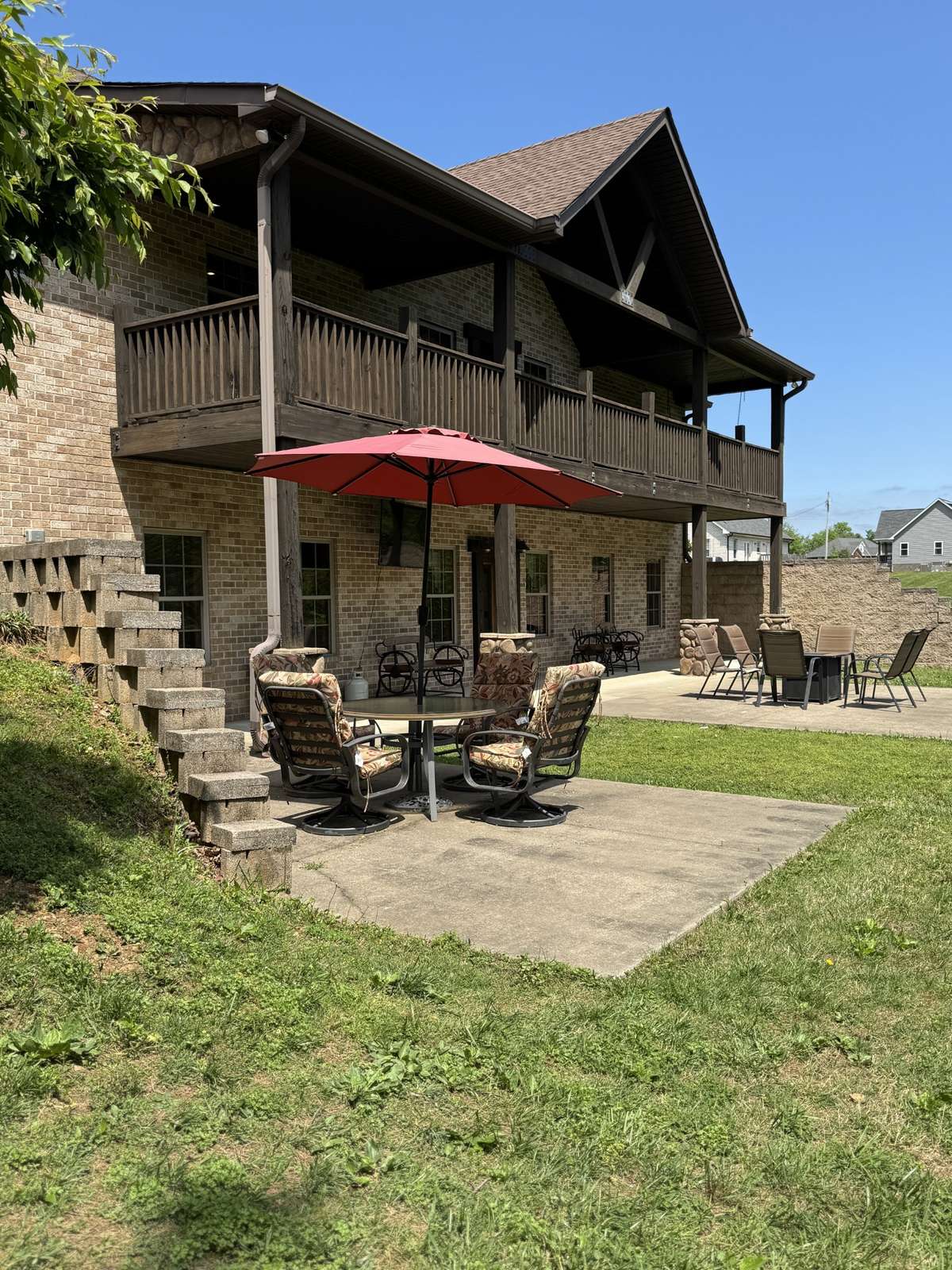 Photo of the back taken during the summer so you can see the green trees and grass, and look forward to warmer days out here!!