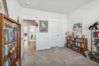 The front bedroom is currently being used as a library and workout area. It features a walk in closet.
