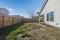 Fenced backyard ideal for pets, play, and entertaining.