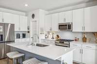 Expansive quartz countertops perfect for prep and entertaining.