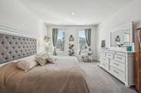 The spacious primary bedroom is bright and airy with plenty of natural light!!