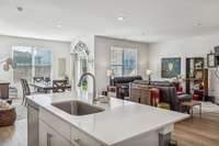 The large kitchen island has the sink and dishwasher and enough space for 2-3 stools.