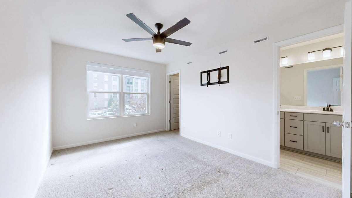 Primary Suite with upgraded custom shade and a walk-in closet.