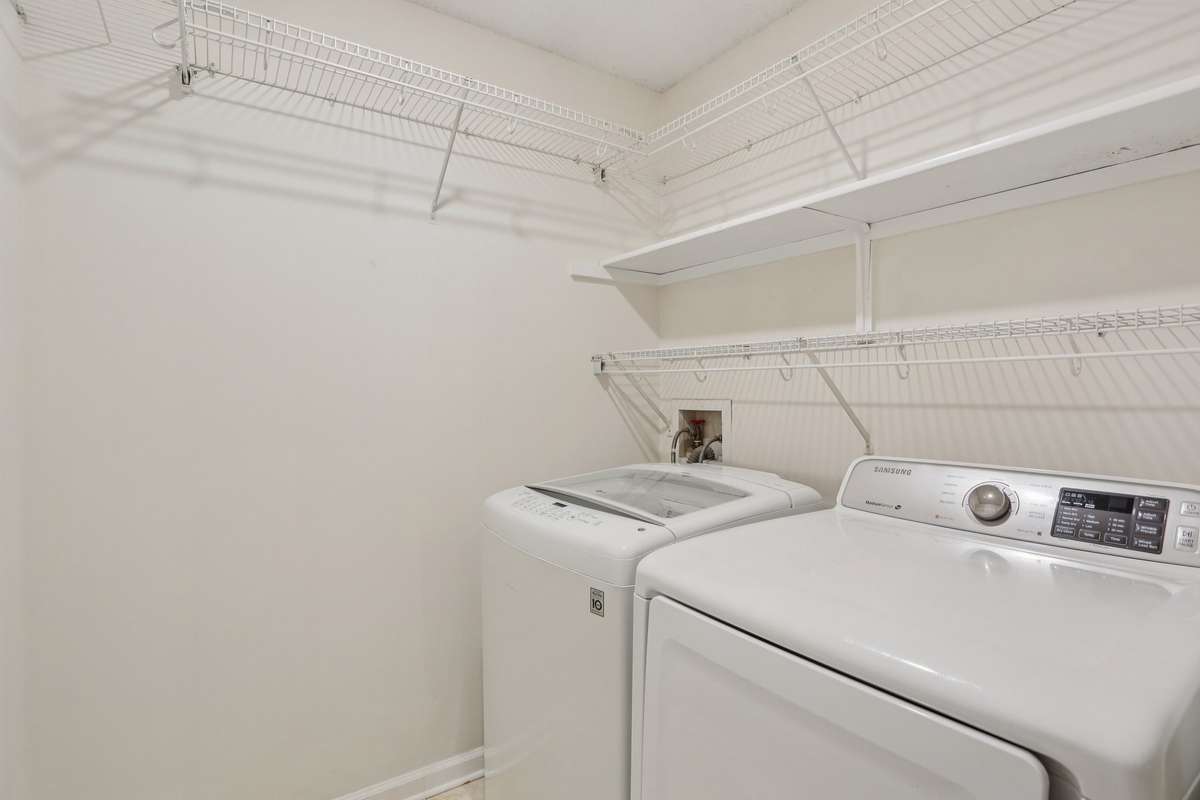 Washer and dryer are included. This is an actual room with extra shelving for added storage.