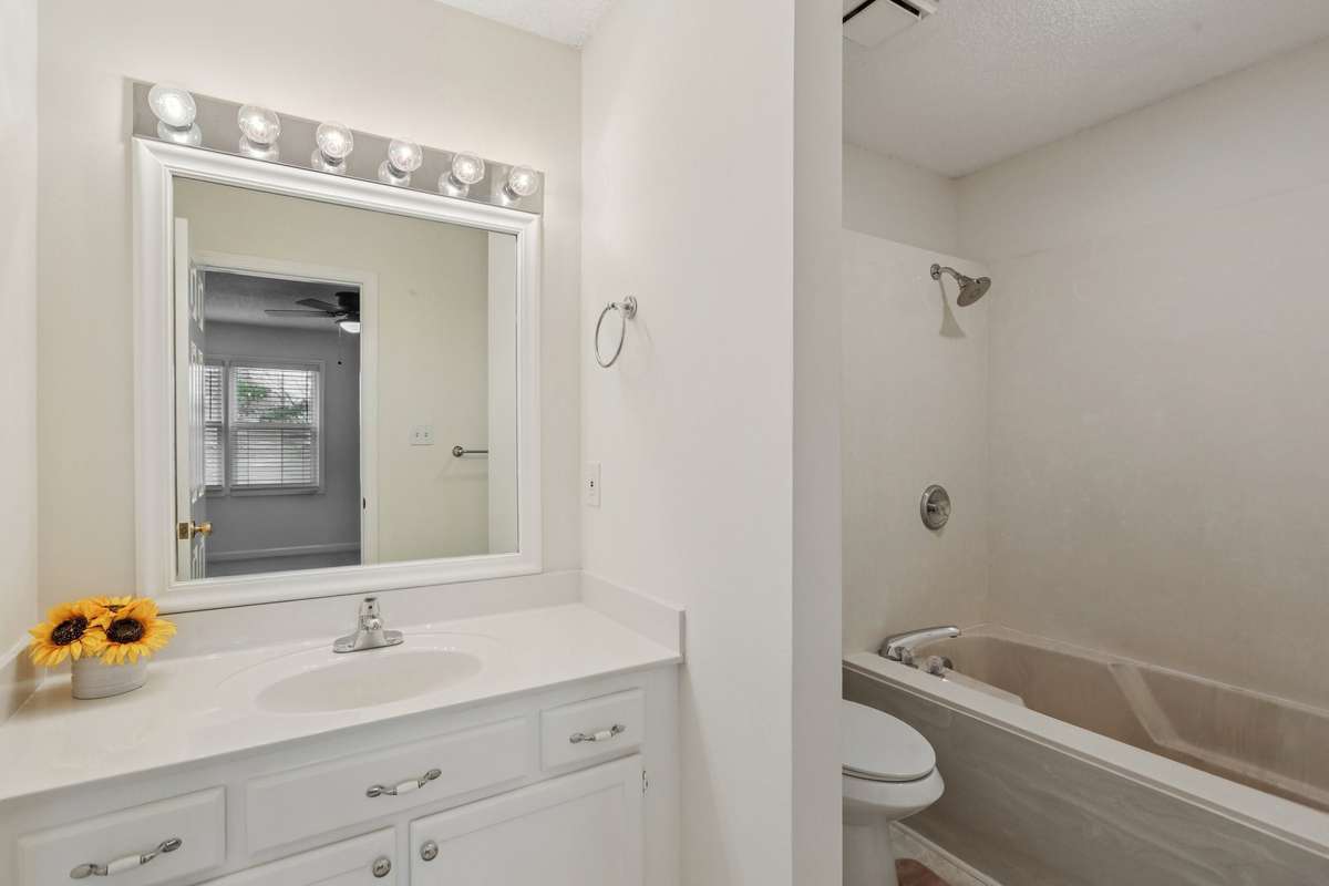 Primary bath with cultured marble tub and surround