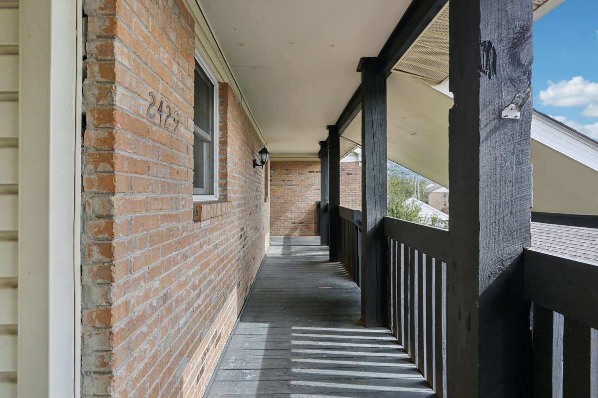 The exterior of this condo is mostly brick with stained cedar columns on the front porch.