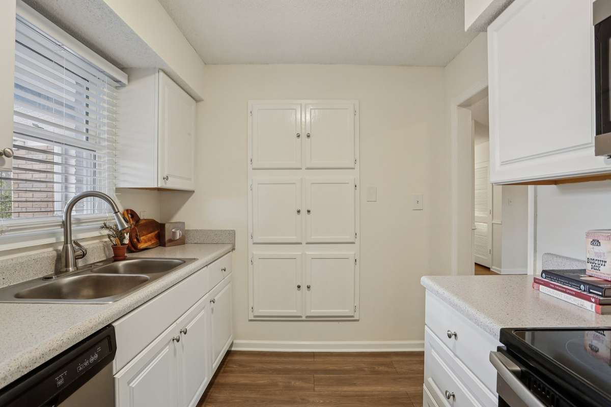 The kitchen is light and bright with a window over the sink. The is extra storage in the built in pantry.