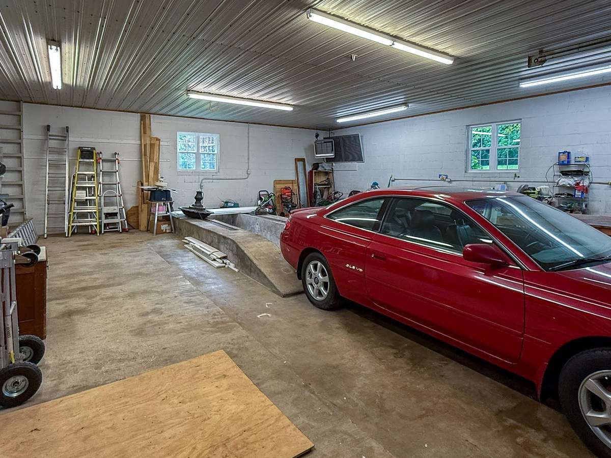 Interior of the shop (and view of lit pit bay to the rear of the vehicle).