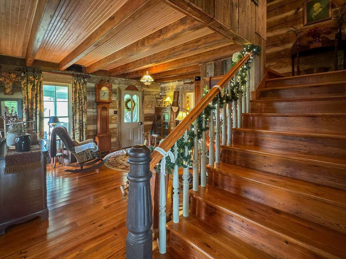 A glowing blend of gleaming wood interiors and original exposed log beams...captivating...