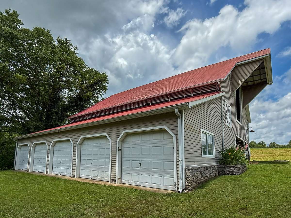 This incredible barn...even has these additional bays for your vehicles or farm implements, if needed...
