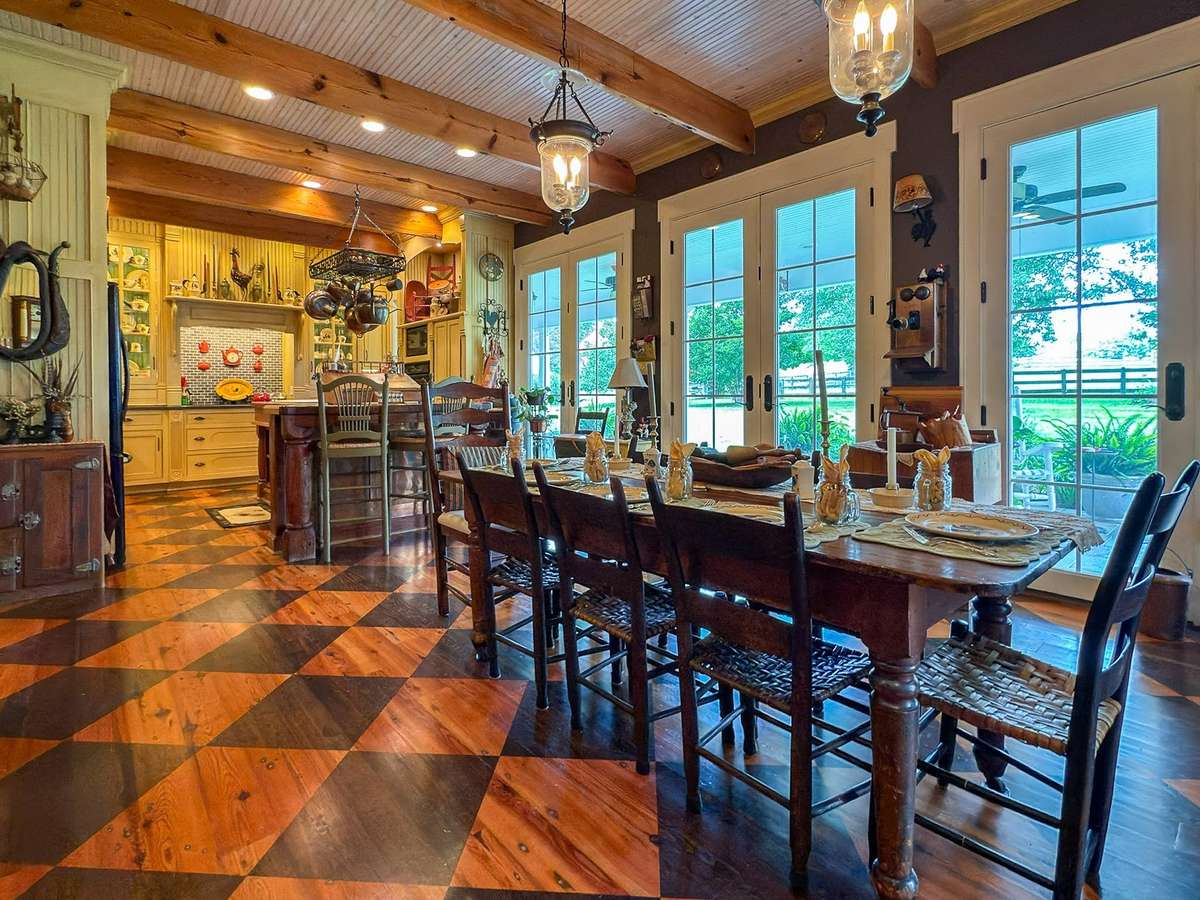 This glowing kitchen with its beautiful custom cabinetry, gorgeous floors, and in-kitchen fireplace is the perfect backdrop for your memorable family meals and gatherings. The space opens seamlessly onto the back patio...easy indoor-outdoor dining...