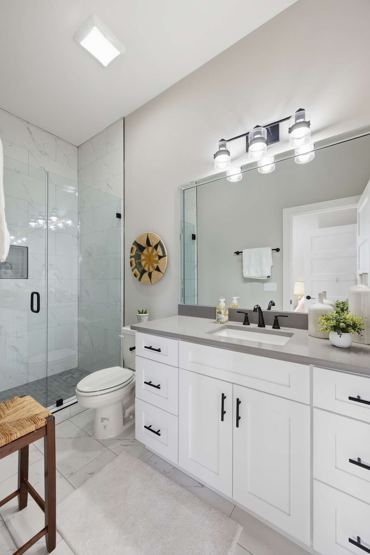 This en-suite bath has a beautifully-tiled full shower.