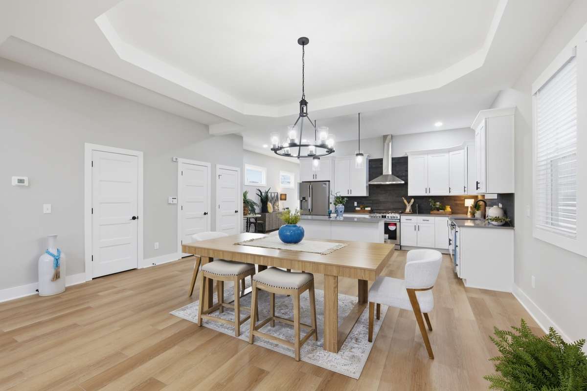 Your dining space is large enough to house an enormous rectangular table if you so choose. The ceiling detailing cleanly defines the space without walls obstructing the floor plan's open-concept.