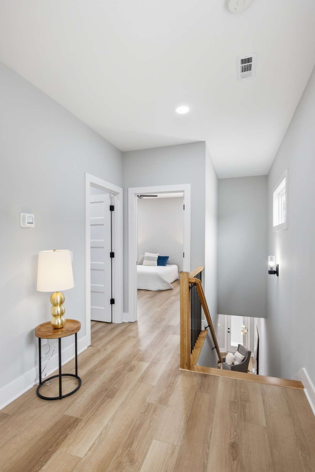 Upstairs, find yourself in this open landing space, where the exceptional flooring continues- there is no carpet in this home!