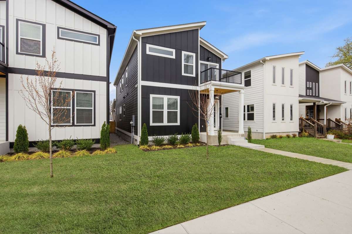 Hardie board siding new construction home offers a covered front porch, upper deck and fenced backyard to enjoy the outdoors.