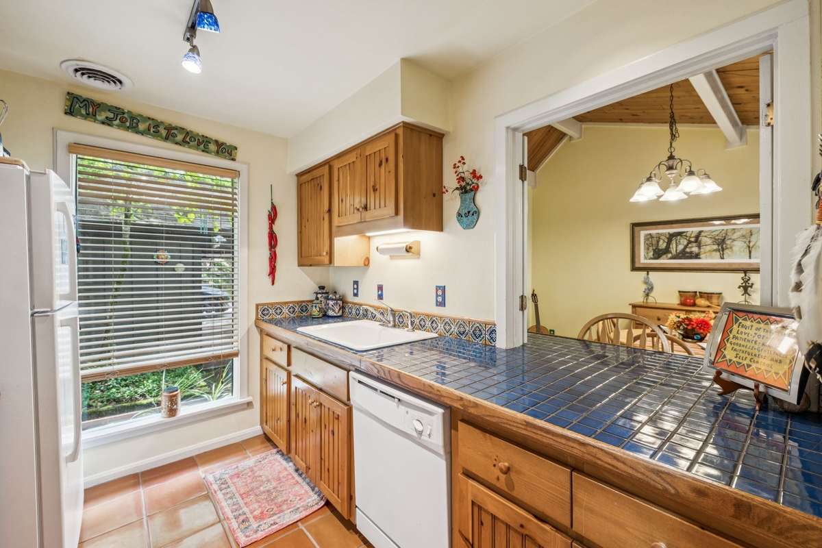 Fully functional kitchen with large pass thru to spacious dining room. All appliances stay such as refrigerator, electric stove, dishwasher.