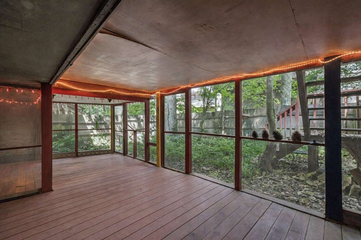 Lower level screened in porch.  Door has access to small yard. There is also a small " doggie door" to let your beloved pet out. Outer  fence as is.