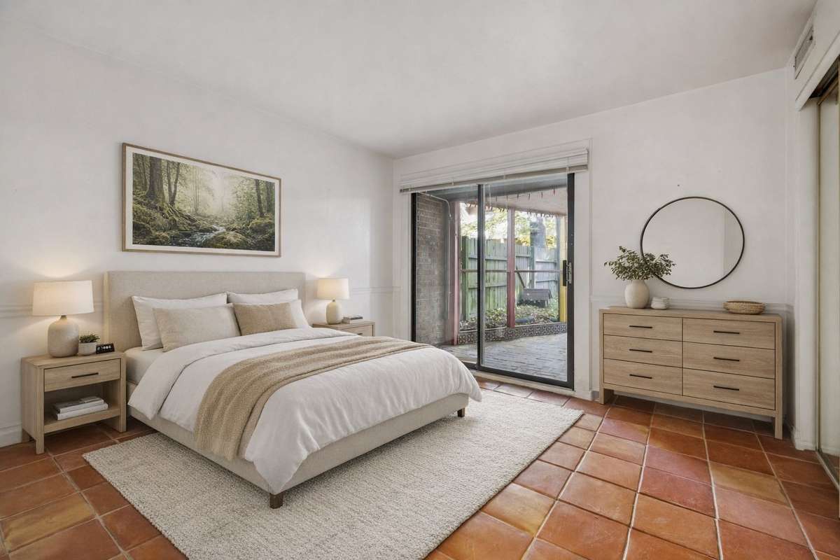 Virtually staged downstairs bedroom with access to comfy screened in porch and small backyard.