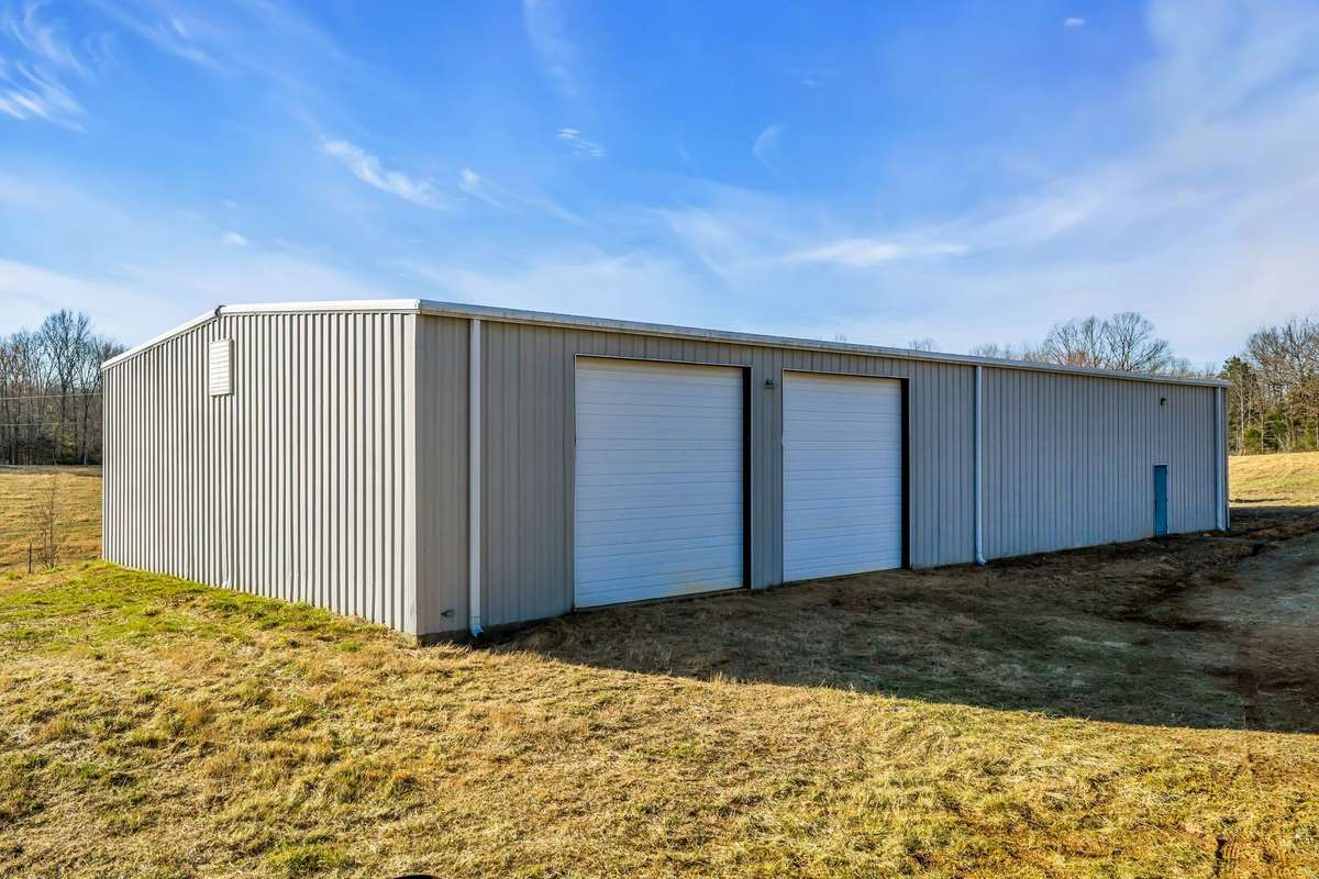 Two Large 14ft roll up garage doors for heavy equipment/vehicle storage.