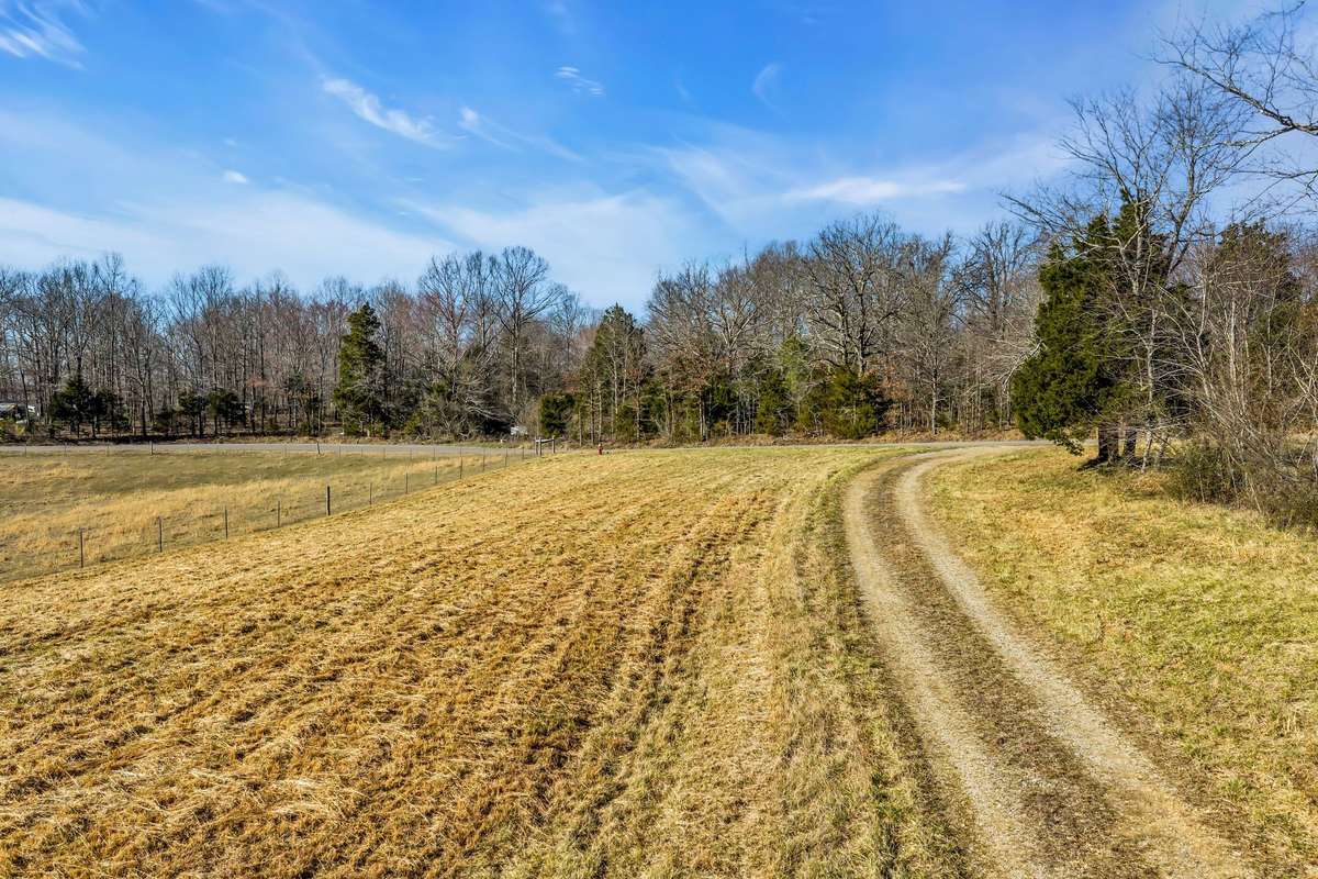 A gravel drive leads into the property.