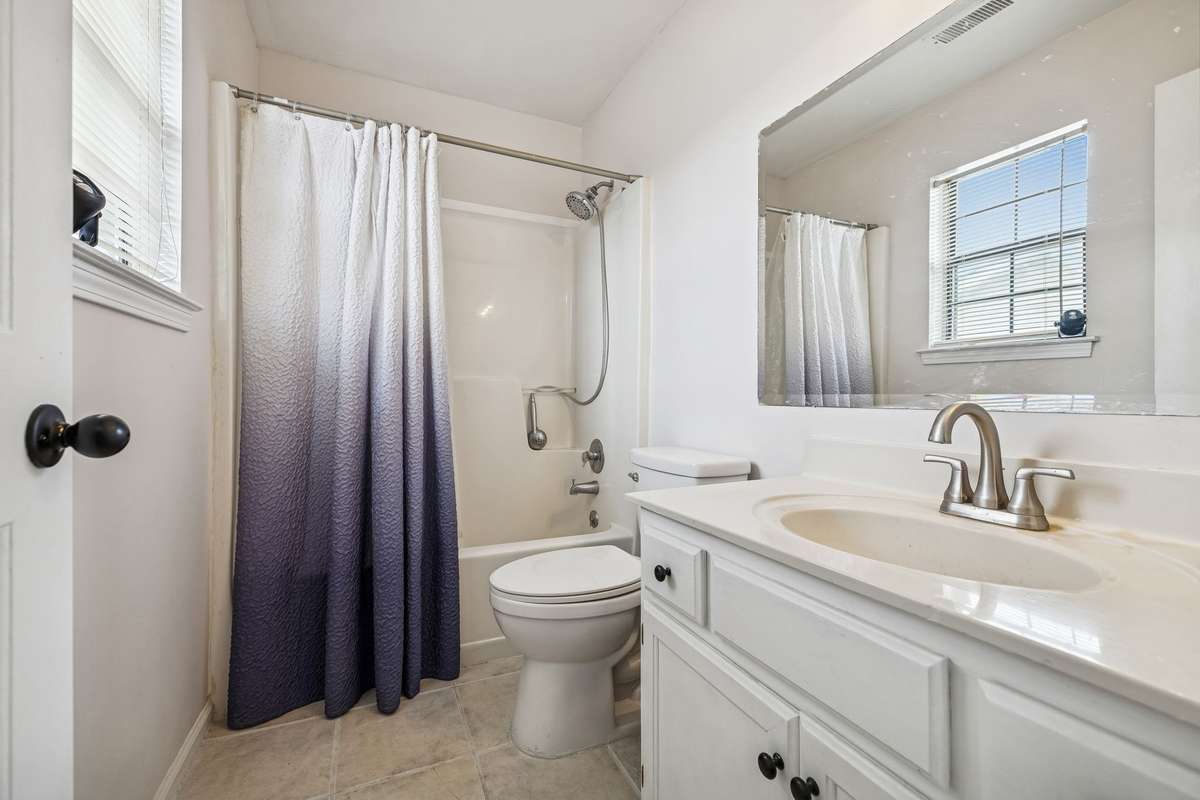 Primary bedroom's bath features an oversized vanity with new faucets and a newly replaced window for natural light! 7701 Poplar Ridge Drive, Nashville, TN 37221