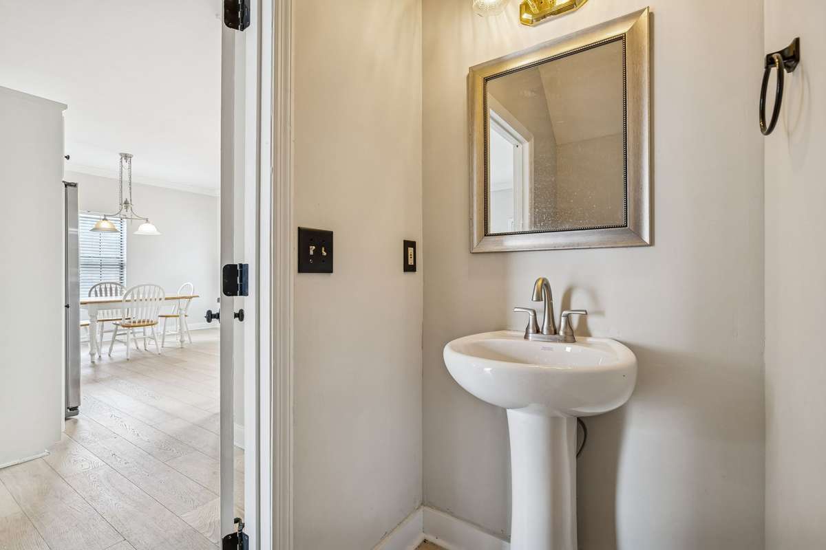 Powder bath on the main level has a new faucet on the pedestal sink. 7701 Poplar Ridge Drive, Nashville, TN 37221