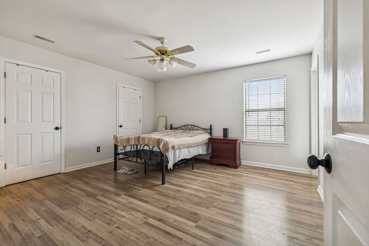 Spacious primary bedroom has fresh paint, solid flooring, and its own full bath! 7701 Poplar Ridge Drive, Nashville, TN 37221