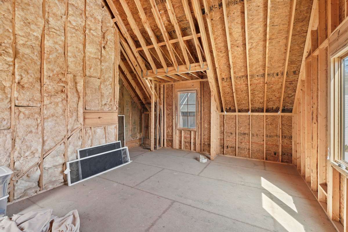 Unfinished space above garage offering additional square footage