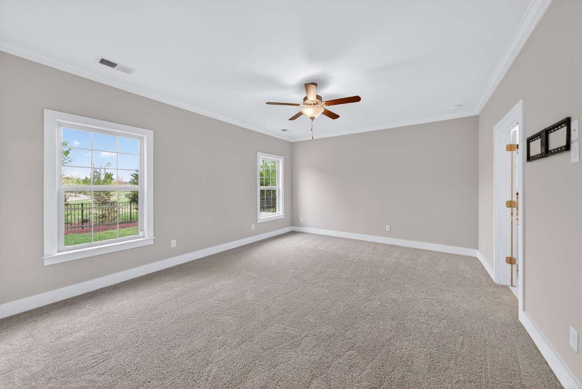 The primary retreat is filled with natural light, creating a bright and restful space to unwind, with an ensuite restroom. .