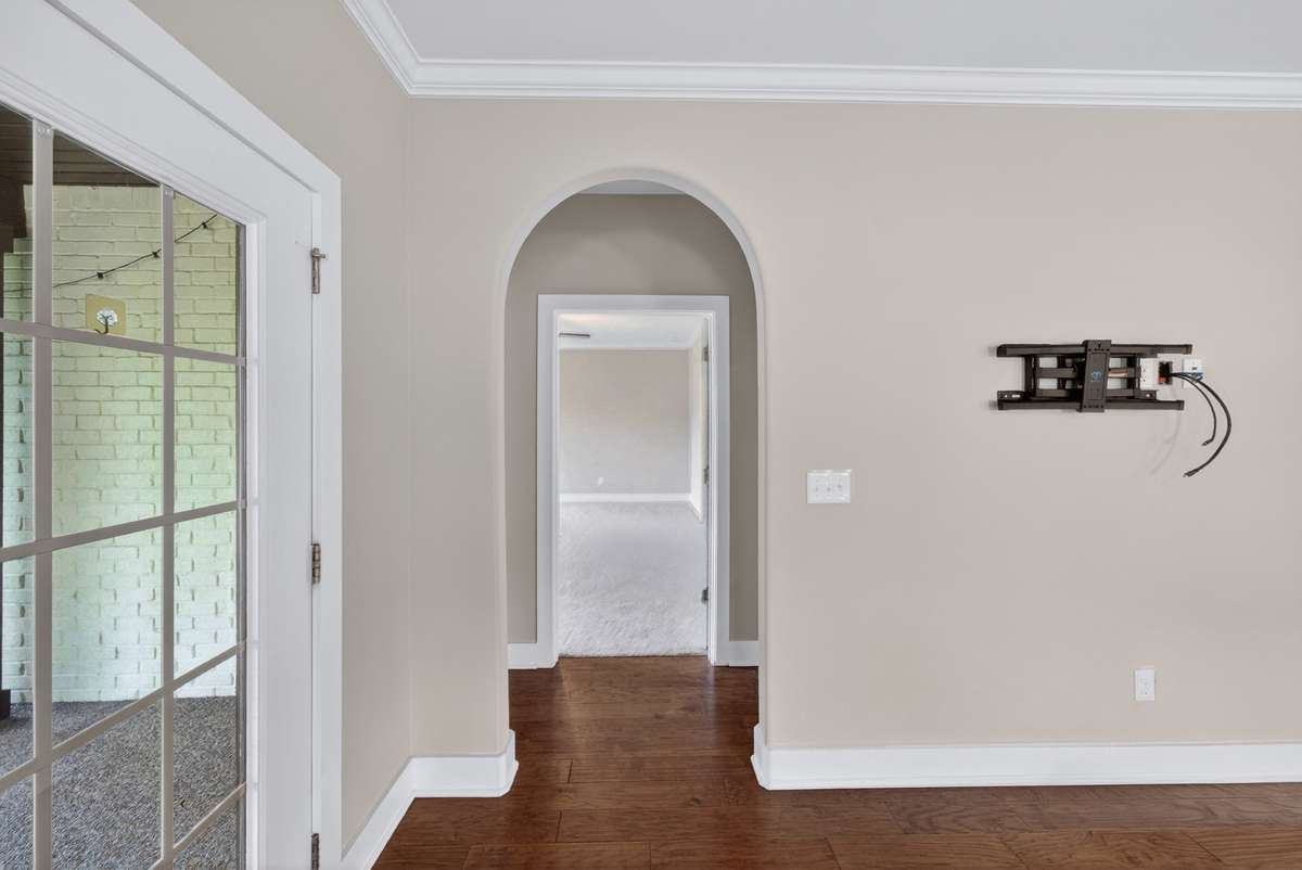 A graceful interior archway leads to the next space, creating a consistent architectural theme that ties the home together with subtle character and flow.