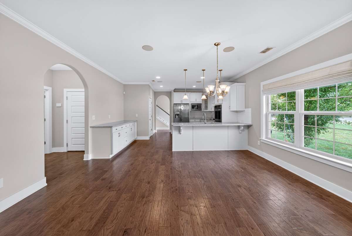 The eat-in kitchen flows seamlessly into the living room, creating an open layout that makes everyday living and entertaining feel connected and effortless.