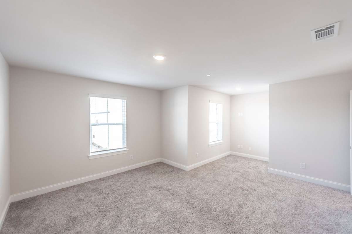 Primary suite offers room for a desk/home office space