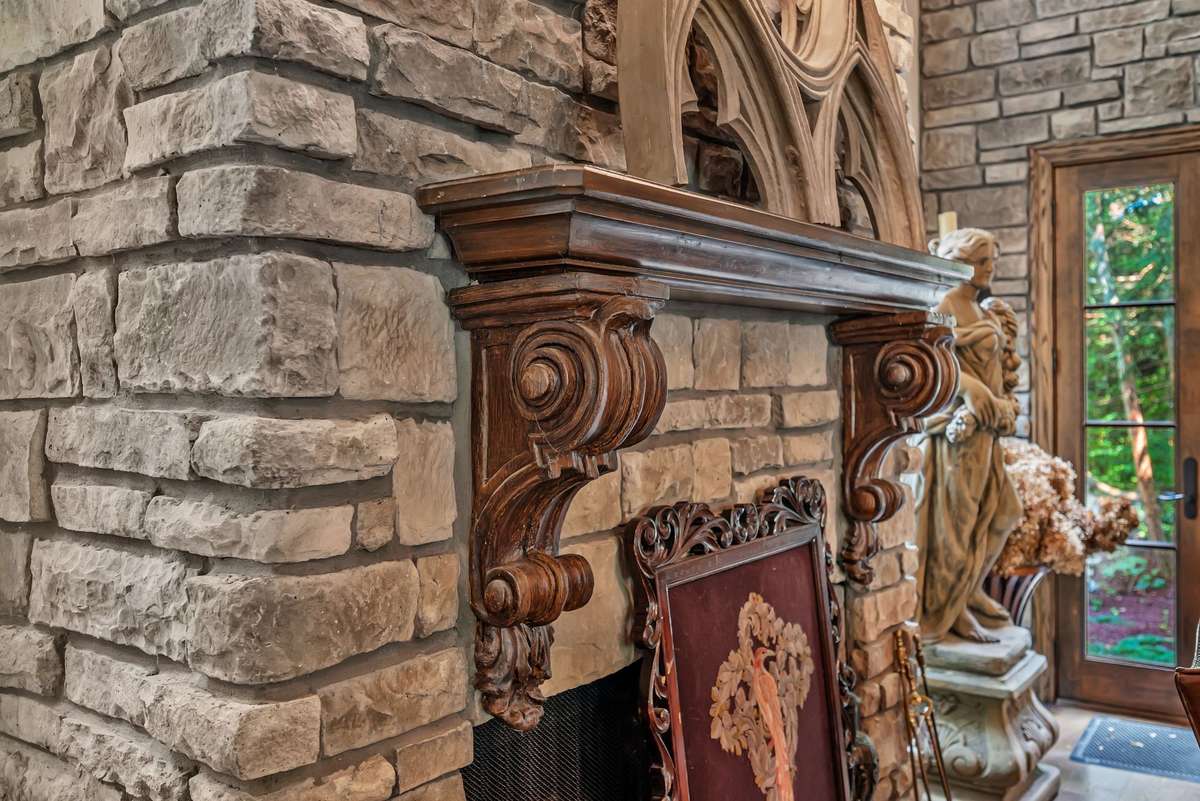 Beautiful stone fireplace and wood carved mantle in the kitchen