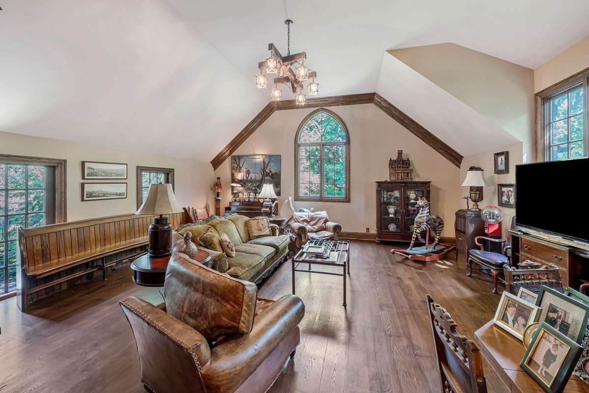 Spacious upstairs media room which overlooks the pool. Steps in kitchen leads to this room, Half bath off of this room