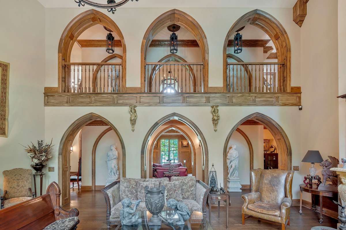 Architectural dream as six  arched openings on both sides of the hallway separate the Library from the Great room and lead you to the main bedroom