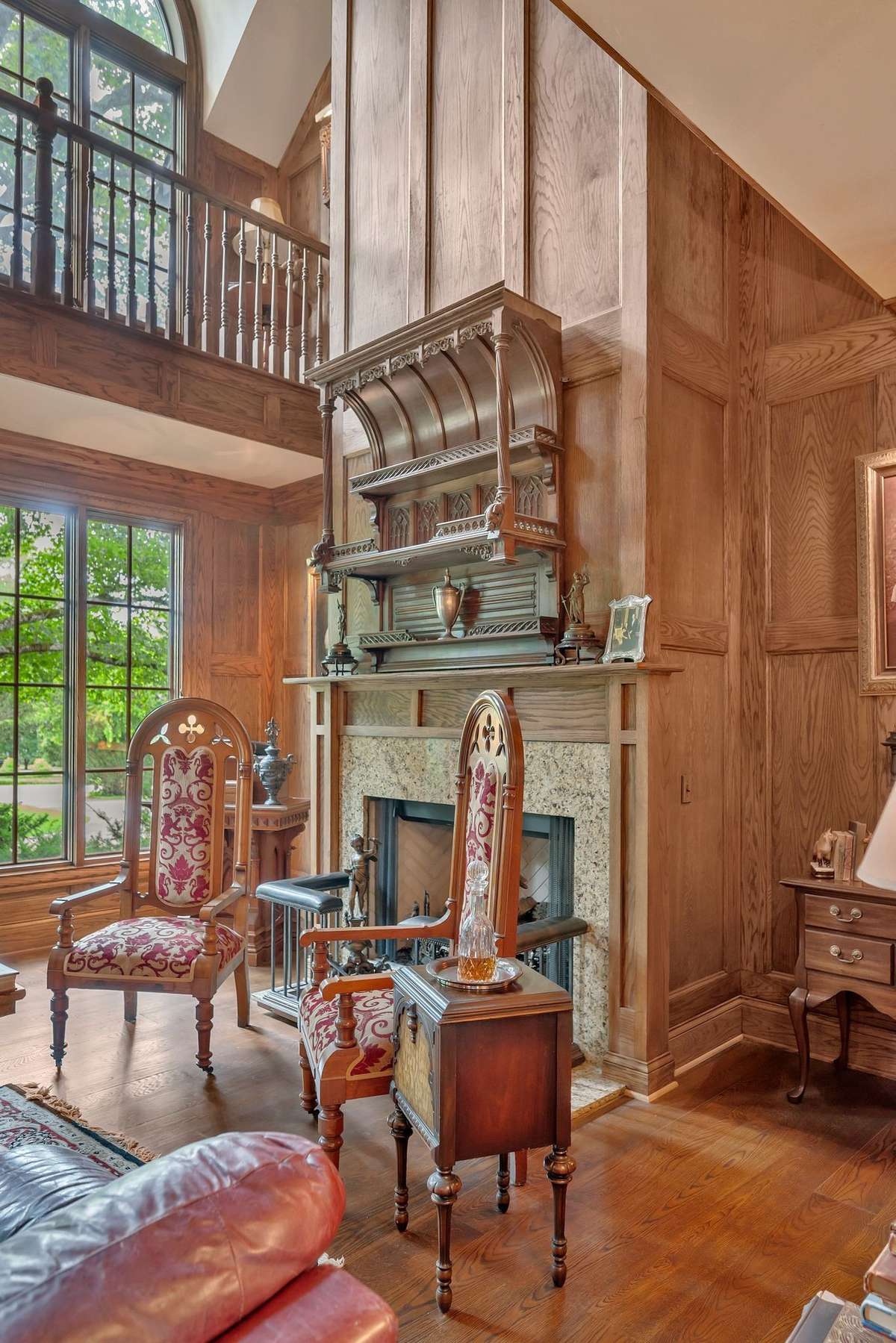 dark rich wood paneling wraps the room in warmth and old world grandeur. When the fire is lit the polished wood creates a moody romantic ambiance that anchors the room