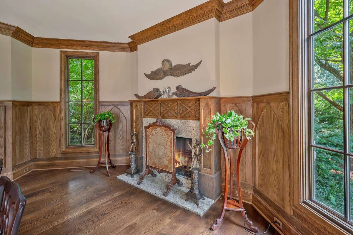 The fireplace is a dramatic focal point echoing detail from old European castles