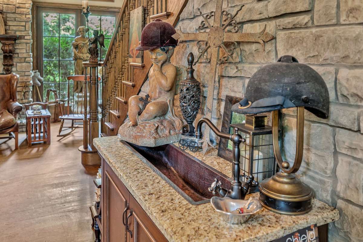 @nd sink in kitchen against stone wall