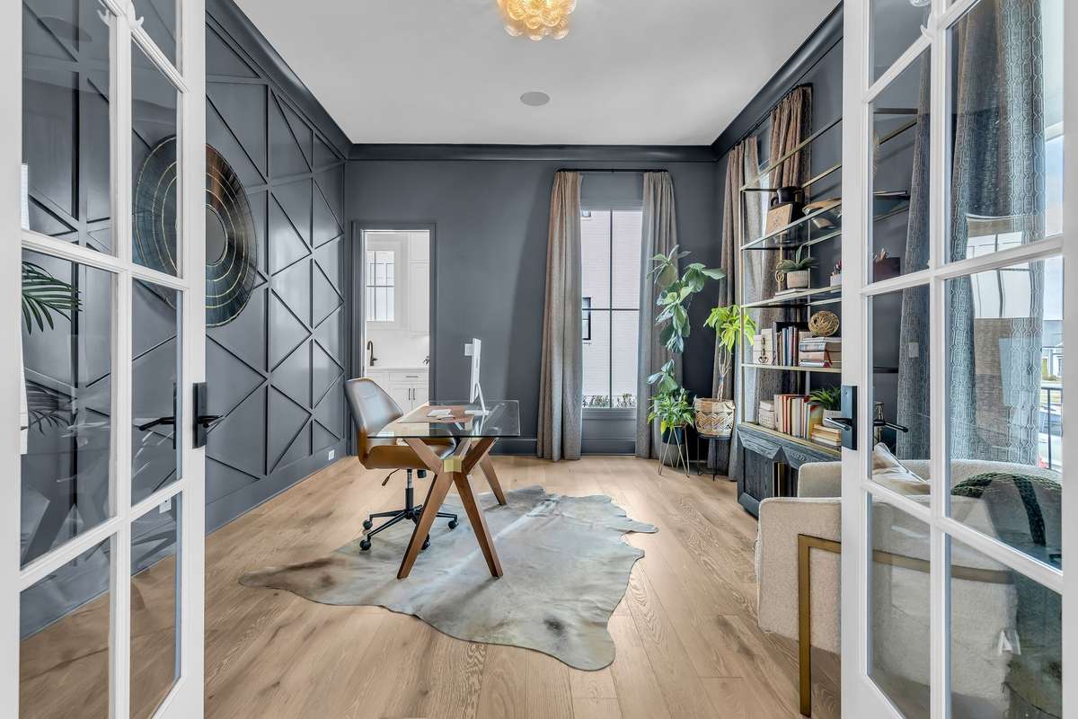 Fabulous office or study at the front of home with custom draperies and color drenched walls.