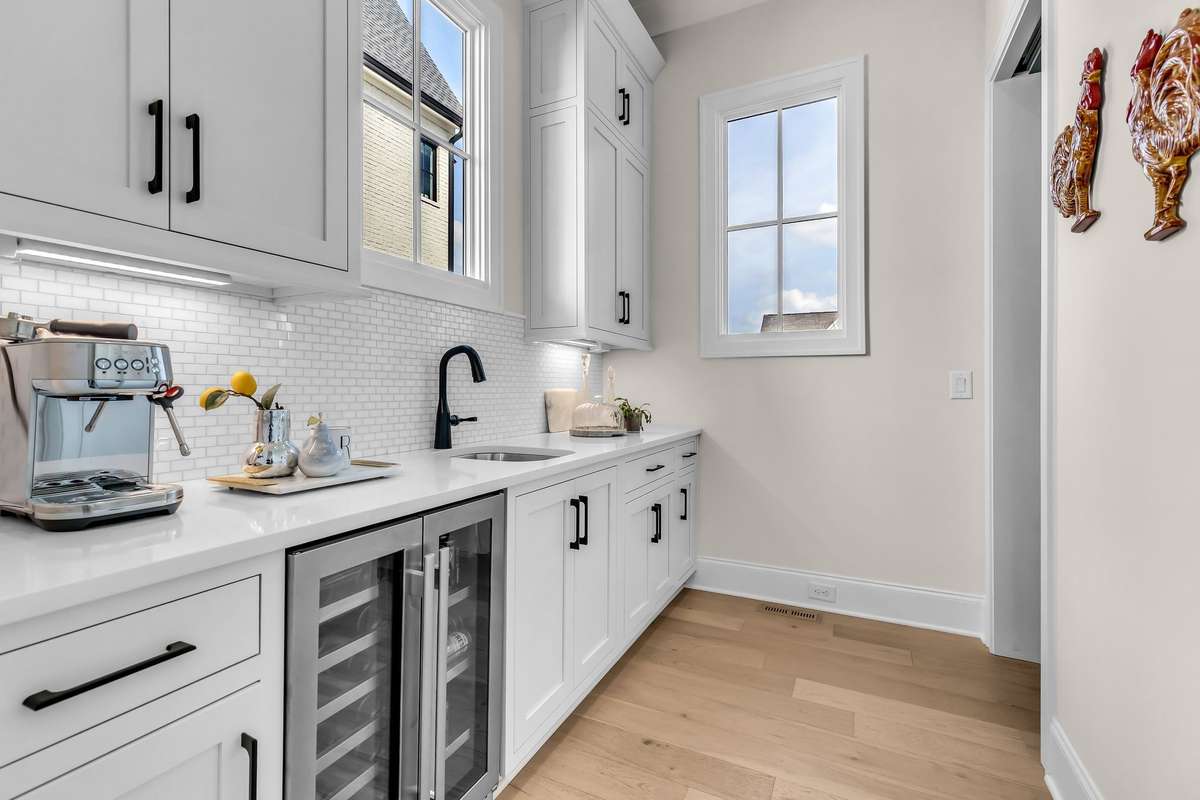Butlers pantry with beverage fridge, wonderful storage and full pantry area as well.