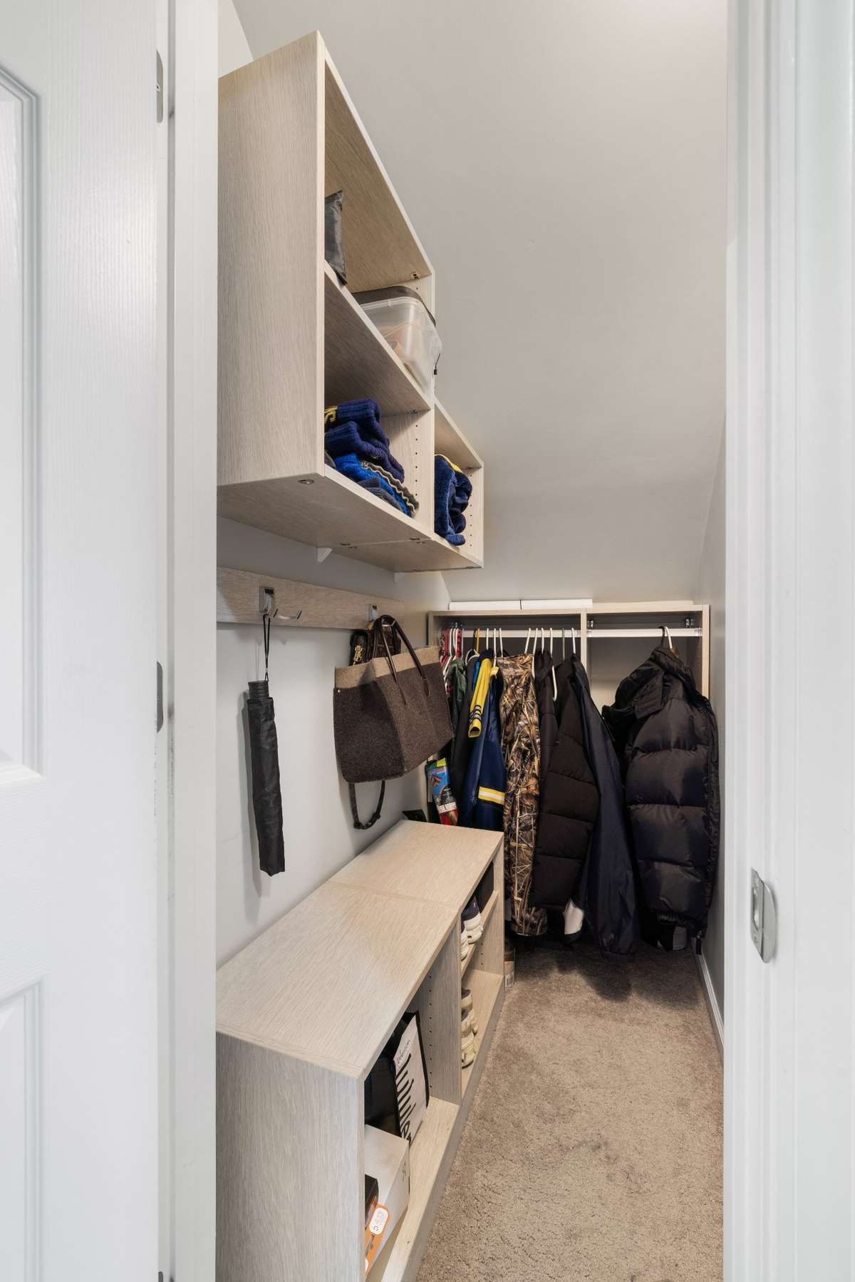 A California closet built under the stairs for coats, shoes, etc...