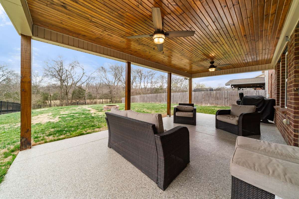 The custom concrete and wood ceilings paired with the fenced yard and views make this the ideal area all summer long!