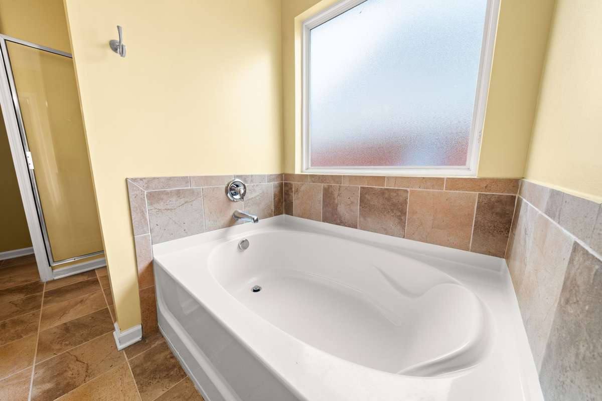 Primary Bathroom: A bathtub fit for a Queen! Grab your glass of wine and relax.